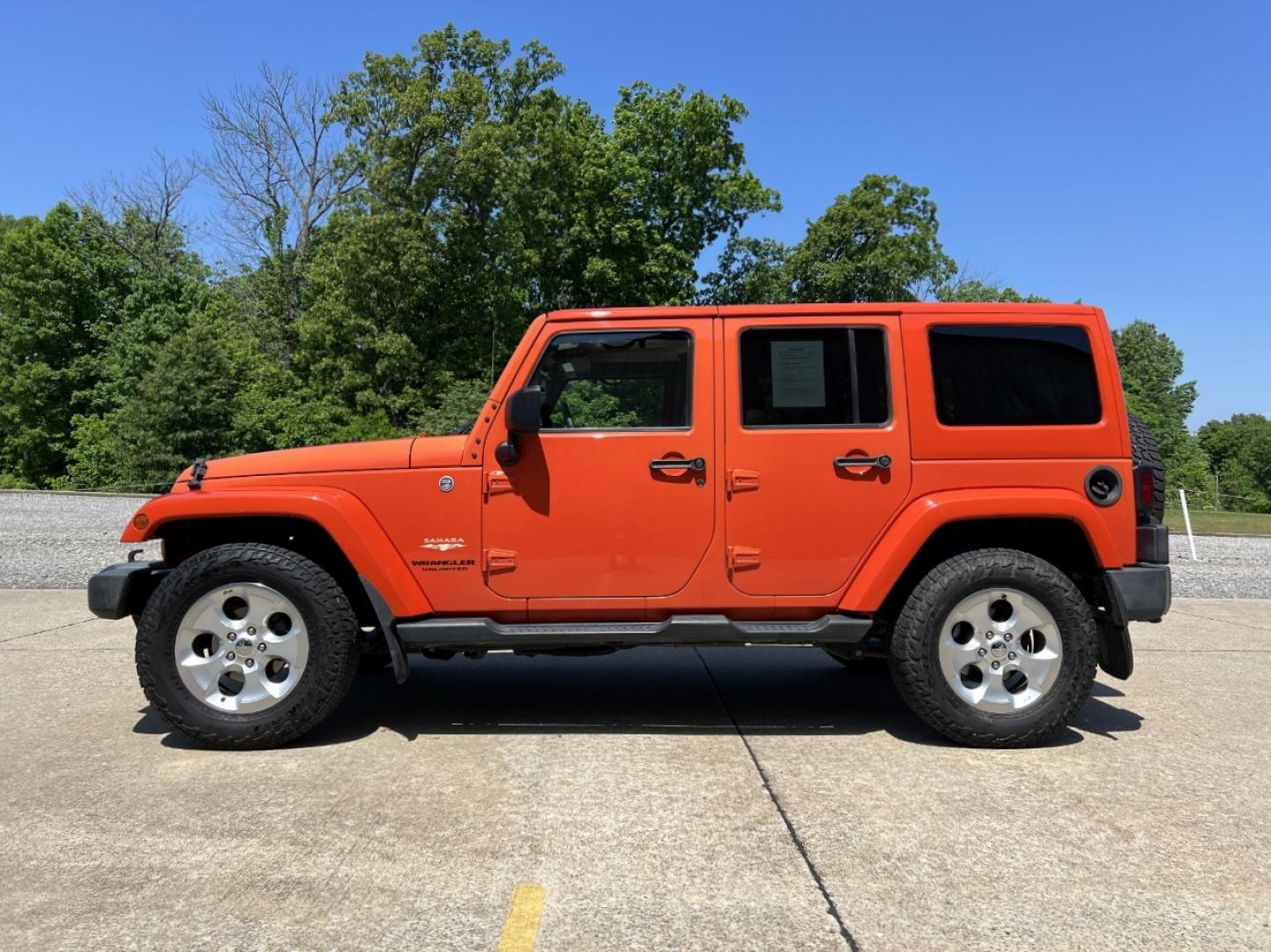 2015 ORANGE /Tan Leather Jeep Wrangler Unlimited Sahara 4WD (1C4BJWEG8FL) with an 3.6L V6 engine, Automatic transmission, located at 506 S. Kingshighway, Cape Girardeau, MO, 63703, (573) 235-5000, 37.294994, -89.556206 - 2015 Jeep Wrangler Unlimited Sahara 103xxx miles 4x4 3.6L V6 Automatic Leather Heated Seats Cruise Power Windows/Locks/Mirrors We have financing available and we accept trades! Fill out a credit application on our website or come by today! If you have any questions, give us a call at (573) - Photo#5