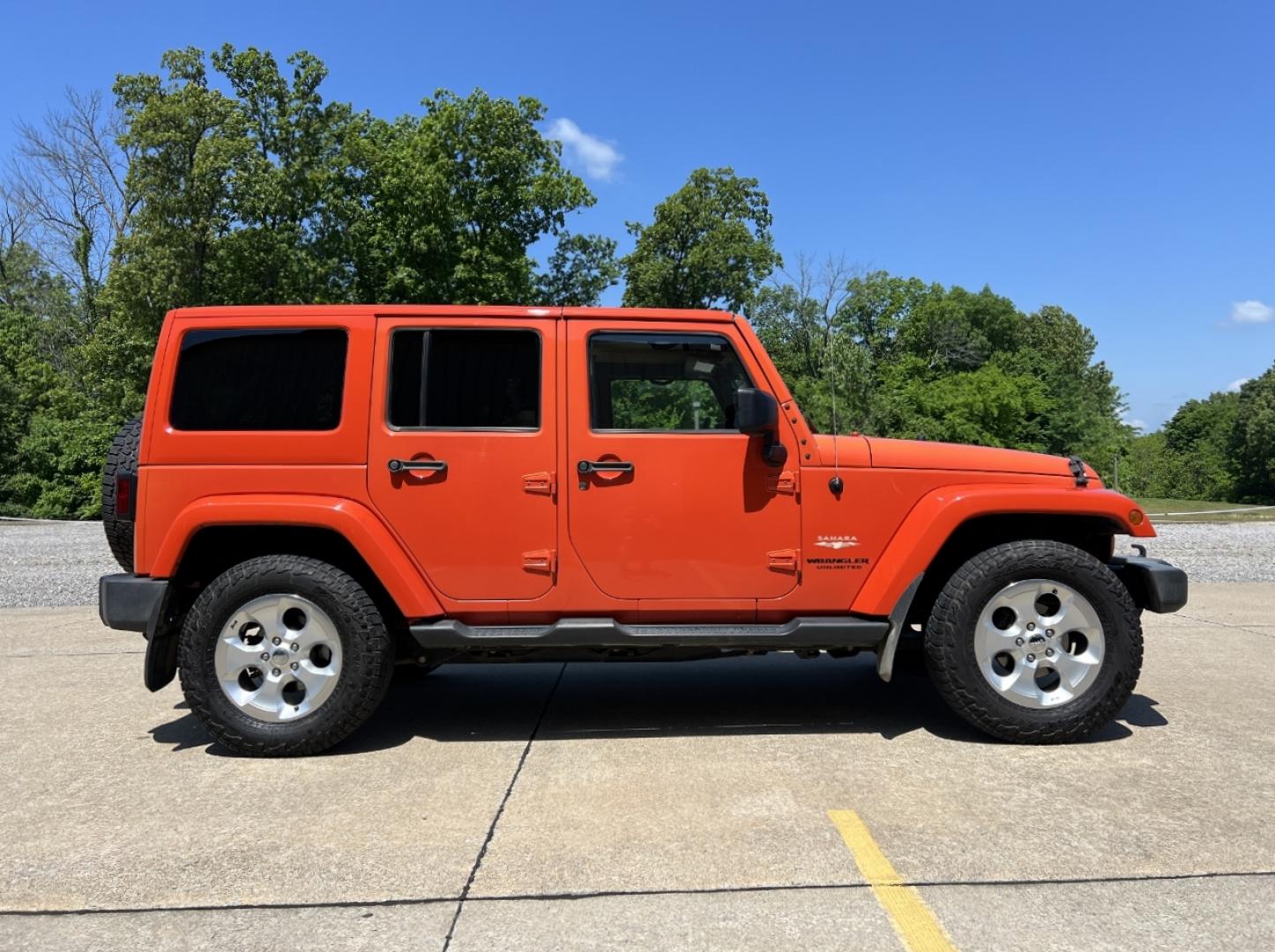 2015 ORANGE /Tan Leather Jeep Wrangler Unlimited Sahara 4WD (1C4BJWEG8FL) with an 3.6L V6 engine, Automatic transmission, located at 506 S. Kingshighway, Cape Girardeau, MO, 63703, (573) 235-5000, 37.294994, -89.556206 - 2015 Jeep Wrangler Unlimited Sahara 103xxx miles 4x4 3.6L V6 Automatic Leather Heated Seats Cruise Power Windows/Locks/Mirrors We have financing available and we accept trades! Fill out a credit application on our website or come by today! If you have any questions, give us a call at (573) - Photo#6