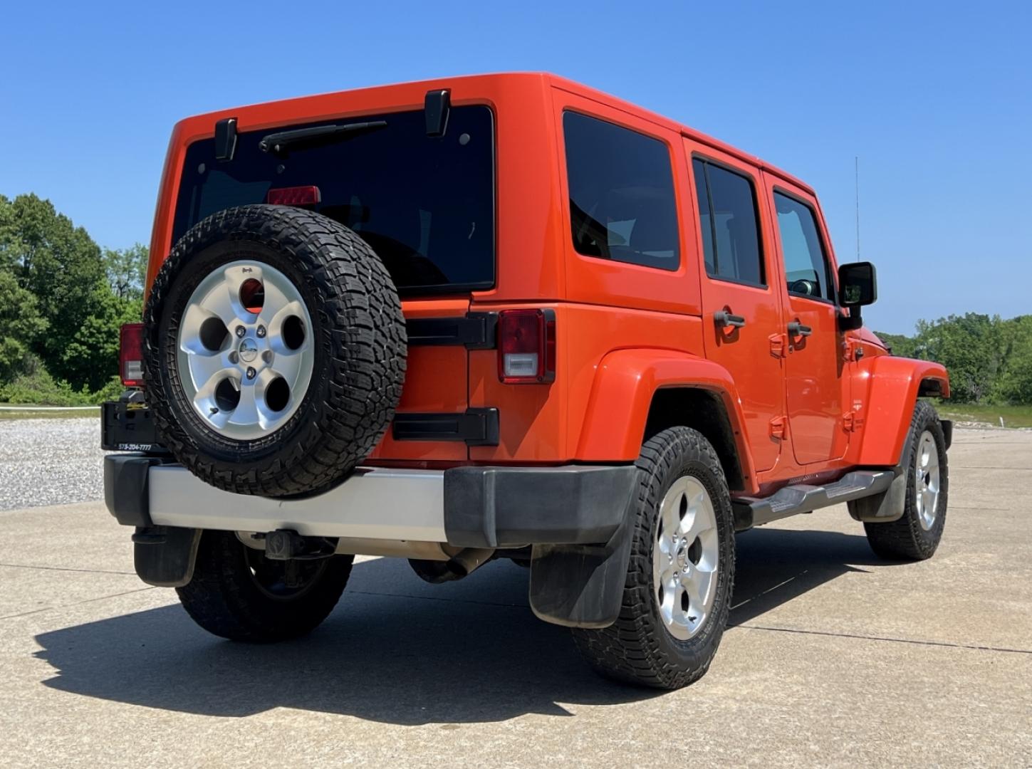 2015 ORANGE /Tan Leather Jeep Wrangler Unlimited Sahara 4WD (1C4BJWEG8FL) with an 3.6L V6 engine, Automatic transmission, located at 506 S. Kingshighway, Cape Girardeau, MO, 63703, (573) 235-5000, 37.294994, -89.556206 - 2015 Jeep Wrangler Unlimited Sahara 103xxx miles 4x4 3.6L V6 Automatic Leather Heated Seats Cruise Power Windows/Locks/Mirrors We have financing available and we accept trades! Fill out a credit application on our website or come by today! If you have any questions, give us a call at (573) - Photo#7