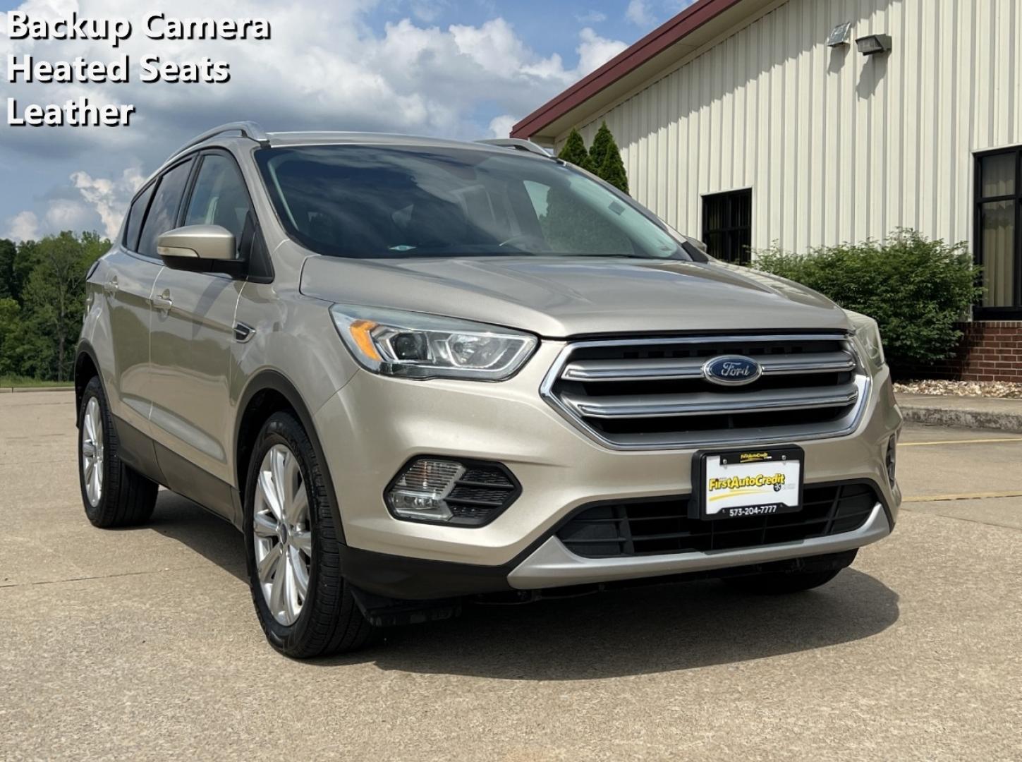 2017 GOLD /Tan Leather Ford Escape Titanium FWD (1FMCU0JD2HU) with an 1.5L 4 Cyl. engine, Automatic transmission, located at 2990 Old Orchard Rd., Jackson, MO, 63755, 37.354214, -89.612106 - 2017 Ford Escape Titanium 86xxx miles Front Wheel Drive 1.5L 4 Cyl. Automatic Leather Power/Heated Seats Backup Camera Bluetooth Remote Start Cruise Power Windows/Locks/Mirrors We have financing available and we accept trades! Fill out a credit application on our website or come by today - Photo#0